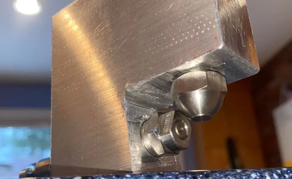 Close-up of a machined block with nozzles fitted.
