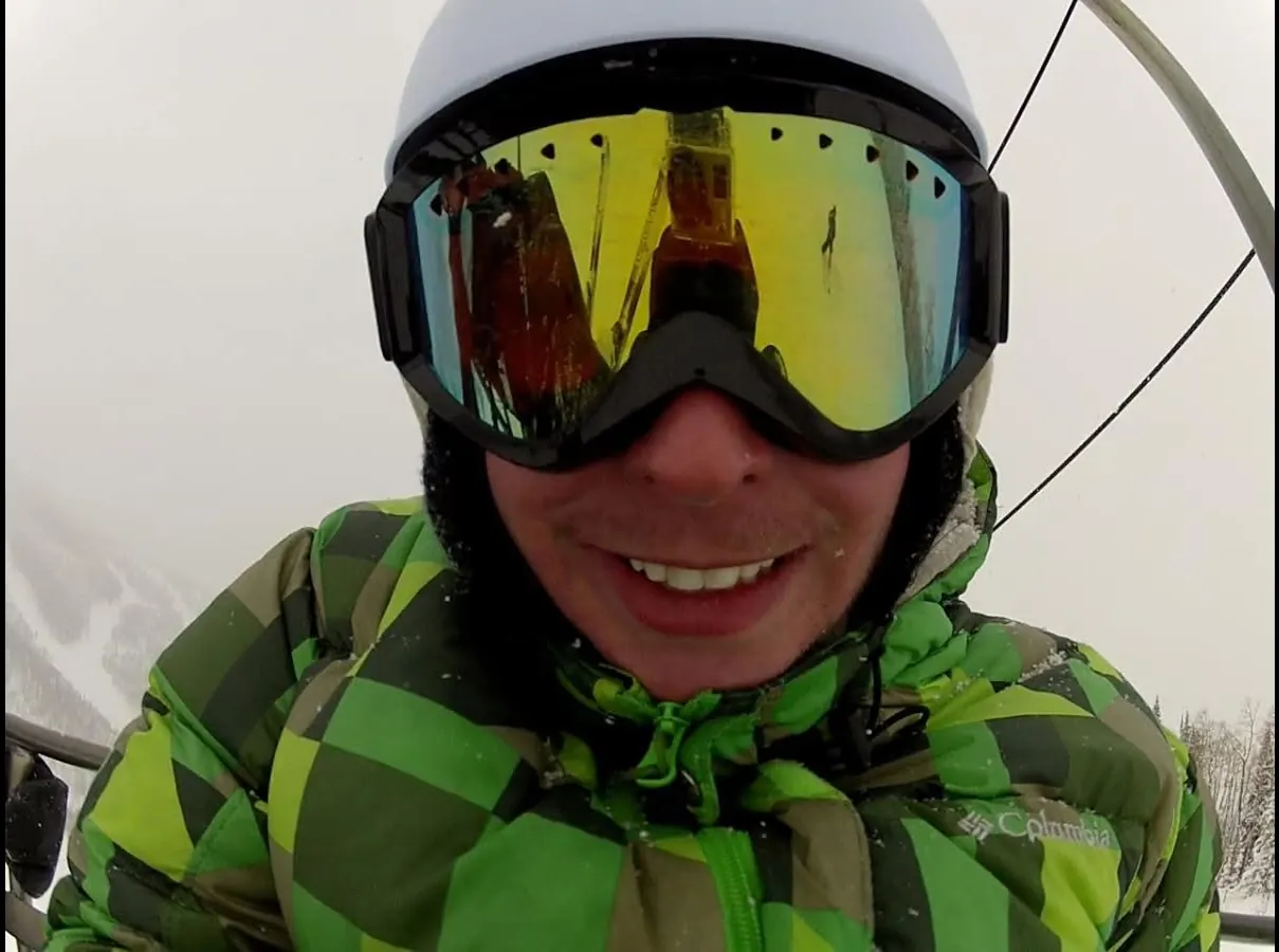 A smiling rider in goggles and a helmet.